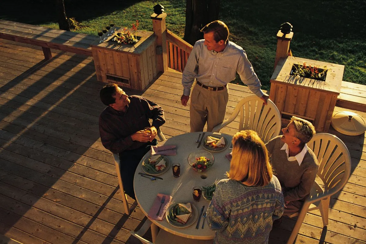 friends having meal on backyard deck