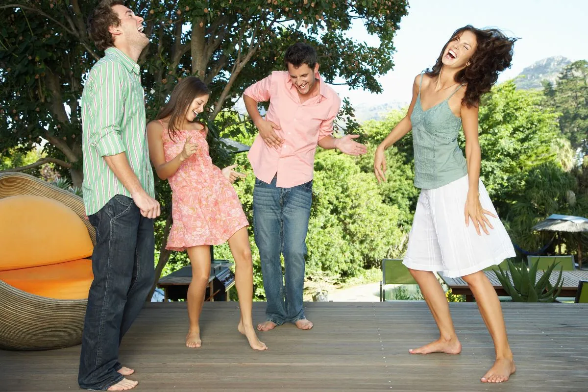 group of friends dancing around on a deck