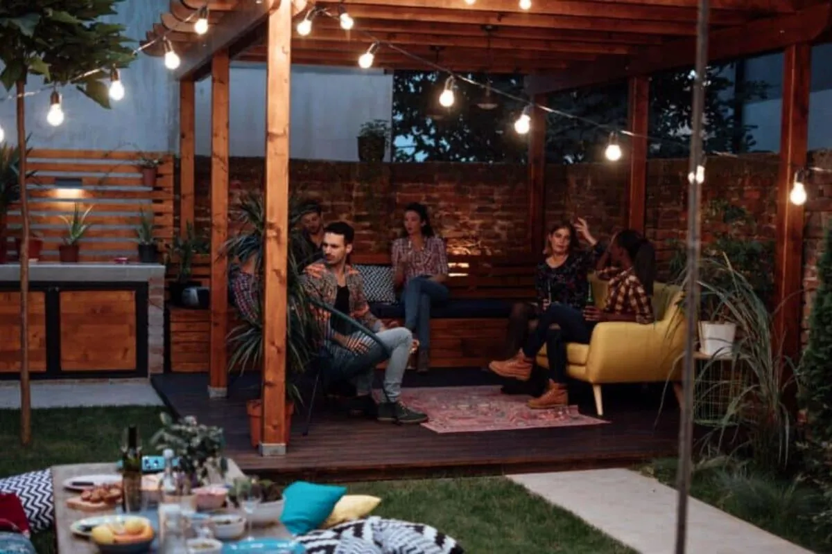 group of friends having a party under pergola