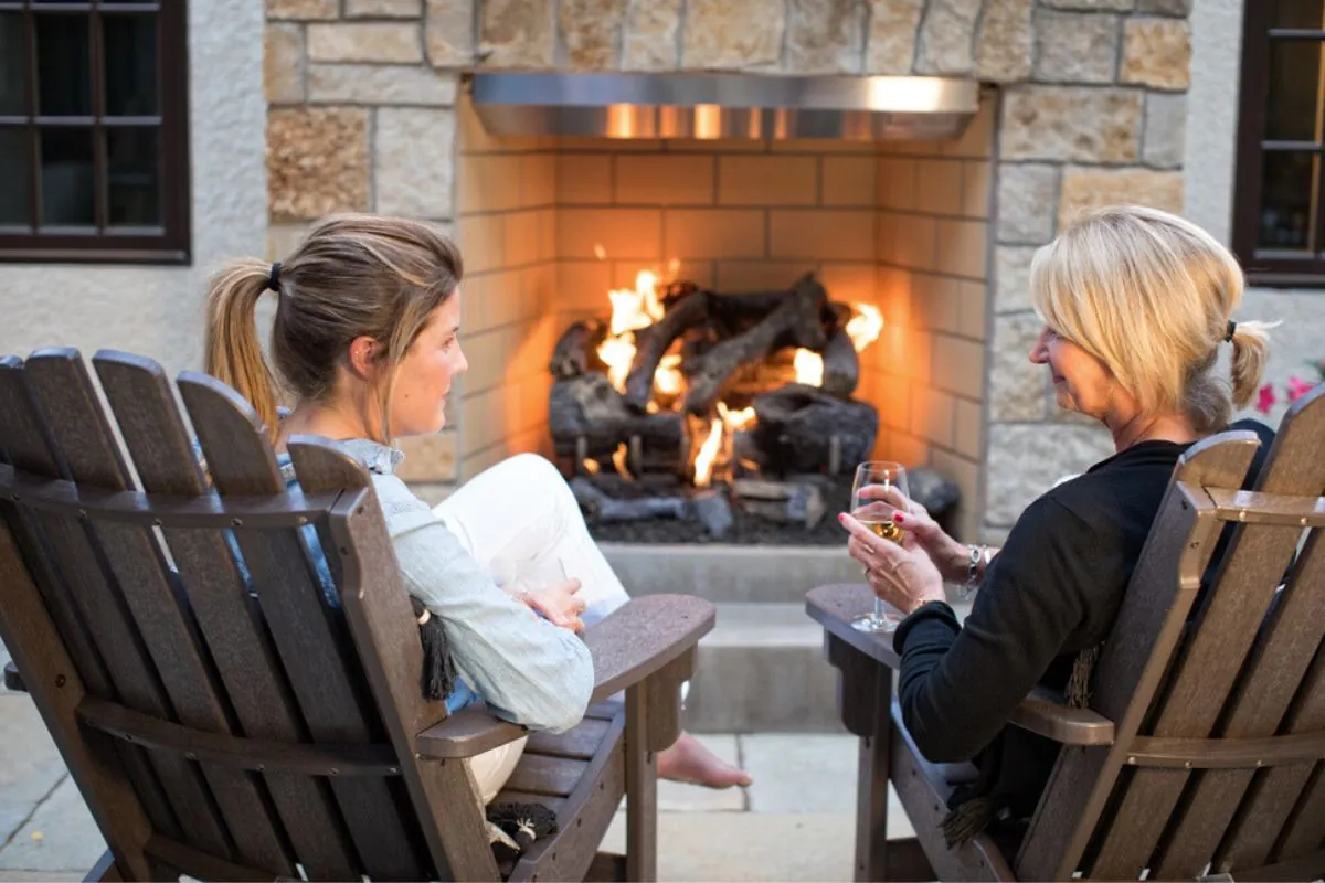 mother daughter conversation in outdoor fireplace