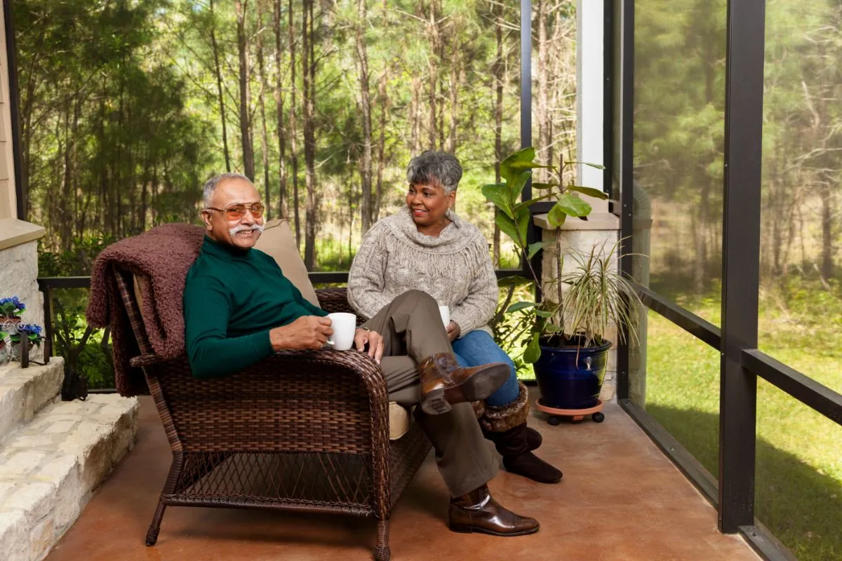 senior couple on screened porch enjoying coffee